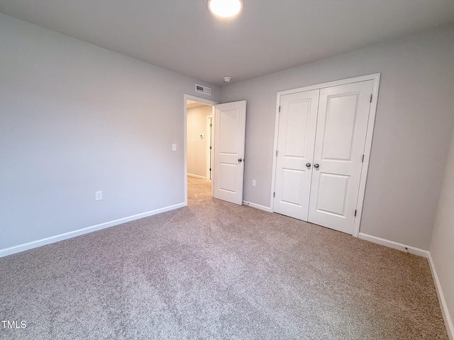 unfurnished bedroom with a closet and carpet