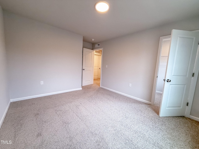 unfurnished bedroom featuring light carpet