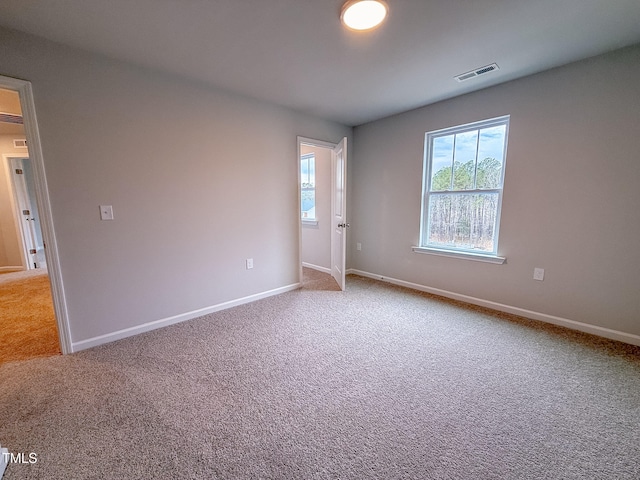 unfurnished room featuring light colored carpet