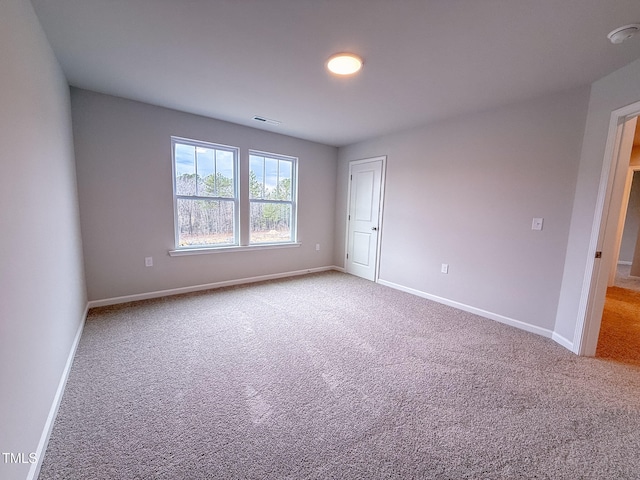 empty room featuring light colored carpet