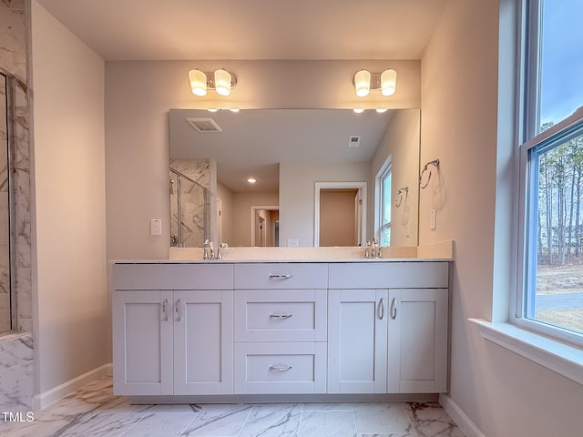 bathroom featuring walk in shower, plenty of natural light, and vanity