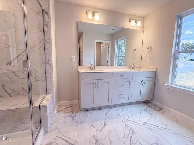 bathroom with vanity and a shower with shower door