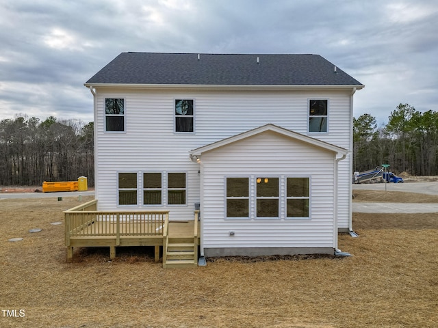 back of house with a wooden deck and a yard