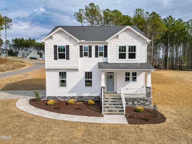 view of front of home with a front yard and covered porch