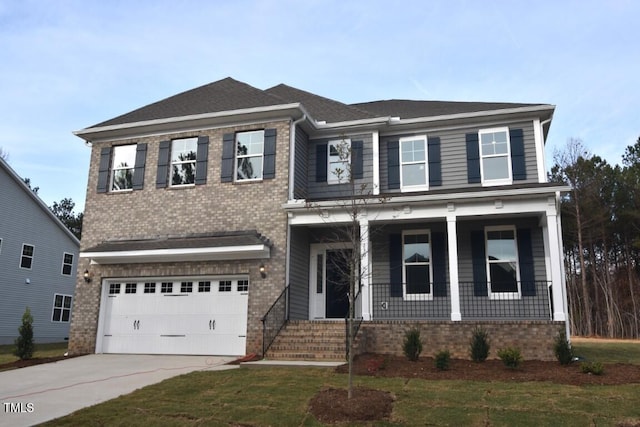 view of front facade with a porch, a garage, and a front yard