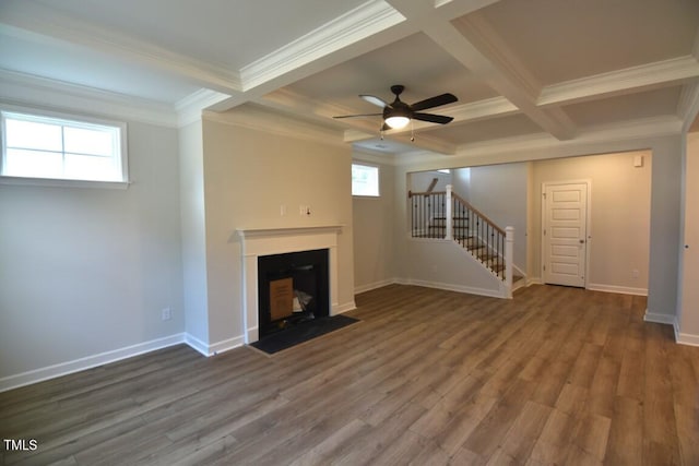 unfurnished living room with wood-type flooring, beamed ceiling, ceiling fan, crown molding, and coffered ceiling