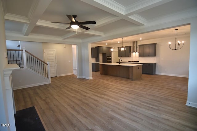 unfurnished living room featuring coffered ceiling, beamed ceiling, and dark hardwood / wood-style flooring