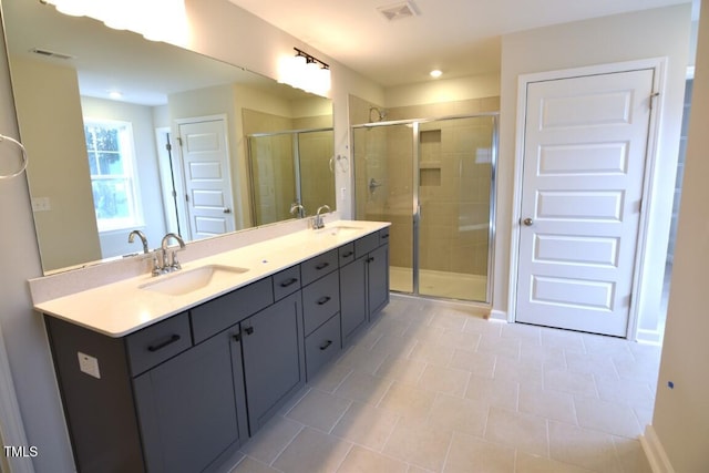 bathroom featuring an enclosed shower and vanity