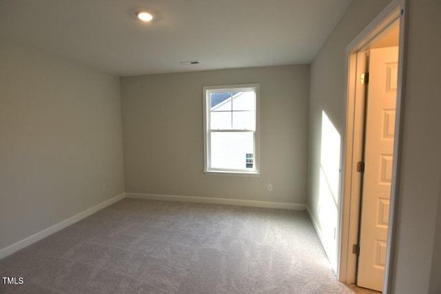 spare room with light carpet