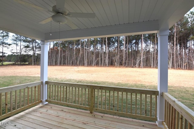 wooden terrace with a yard and ceiling fan