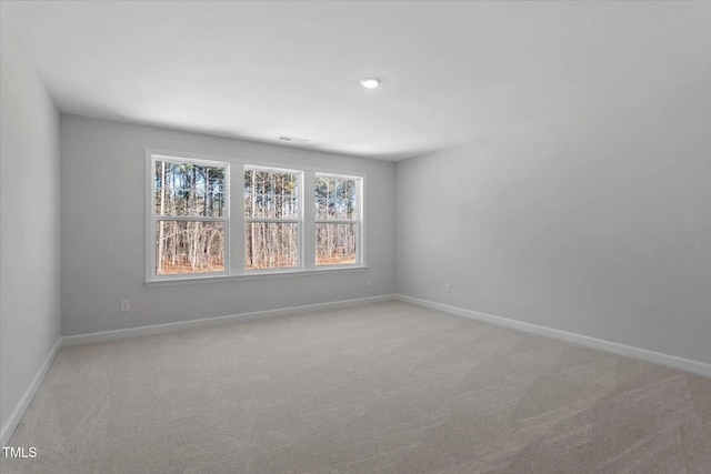 unfurnished room with light colored carpet