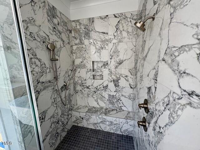 bathroom with tiled shower