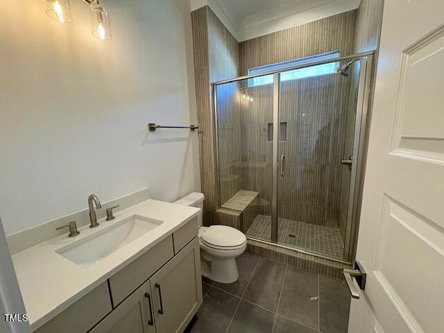 bathroom with vanity, an enclosed shower, tile patterned floors, and toilet