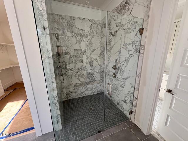 bathroom featuring tile patterned floors and an enclosed shower