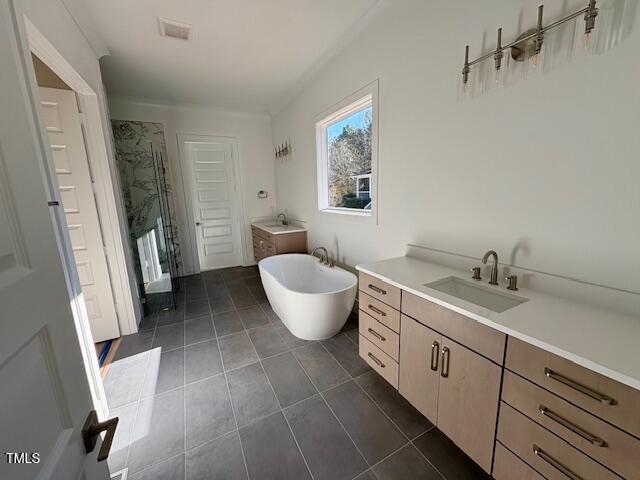 bathroom with tile patterned floors, vanity, and shower with separate bathtub