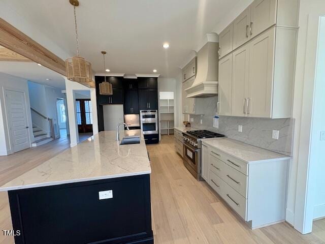 kitchen featuring a spacious island, stainless steel appliances, hanging light fixtures, and custom range hood