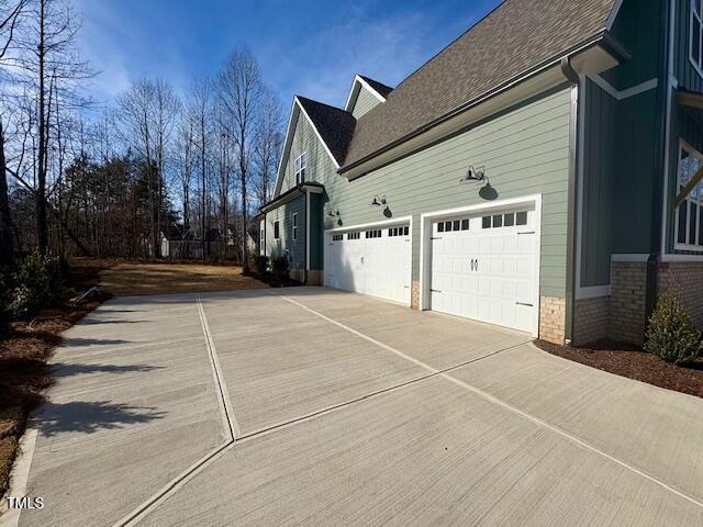 view of side of home with a garage