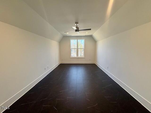 additional living space with lofted ceiling and ceiling fan