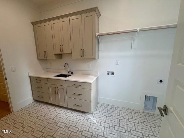 washroom featuring washer hookup, sink, cabinets, and hookup for an electric dryer