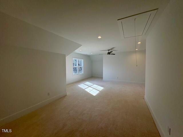 bonus room featuring light colored carpet and vaulted ceiling