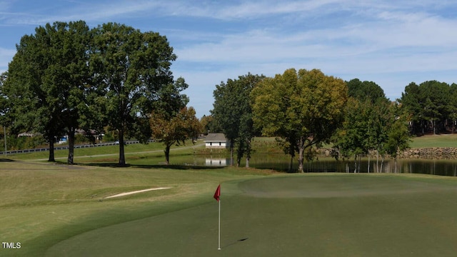 view of community featuring a lawn and a water view