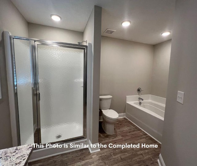 bathroom with wood-type flooring, toilet, and plus walk in shower