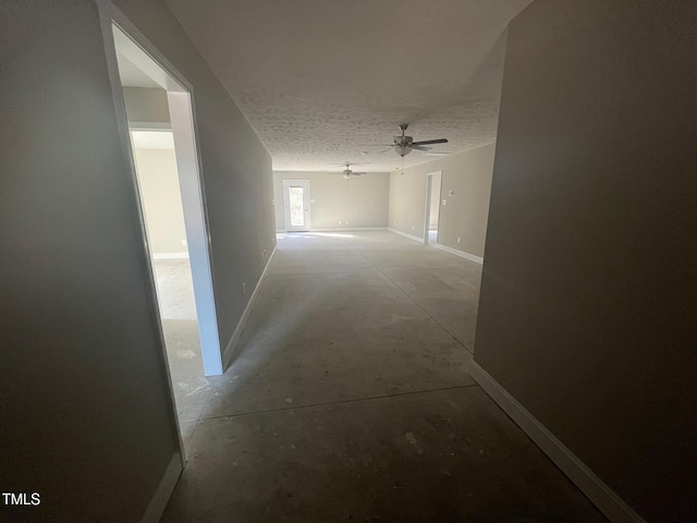 hall featuring a textured ceiling