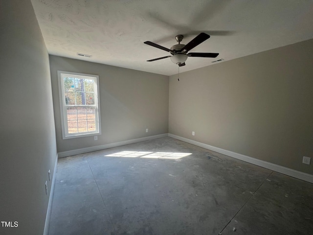 empty room with concrete flooring and ceiling fan