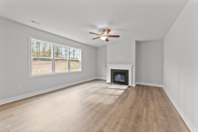 unfurnished living room with light wood-type flooring and ceiling fan