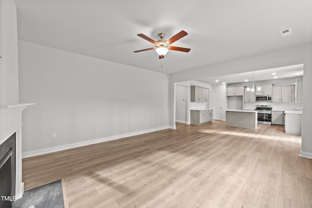 unfurnished living room featuring light wood-type flooring and ceiling fan