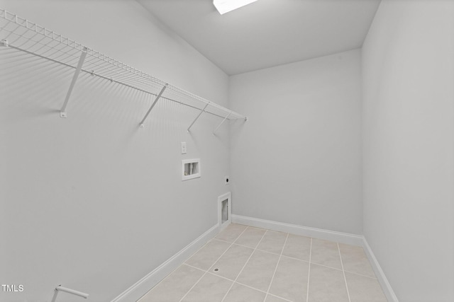 washroom featuring washer hookup, light tile patterned floors, and electric dryer hookup