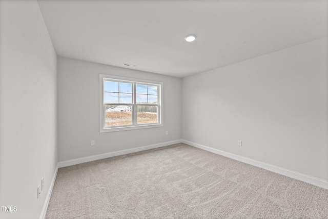 spare room with light colored carpet