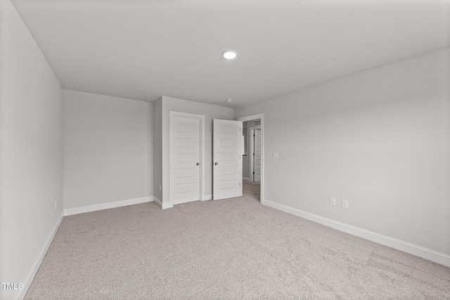 unfurnished bedroom featuring light colored carpet