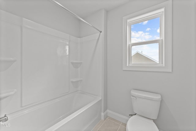 bathroom featuring toilet, shower / tub combination, and tile patterned floors