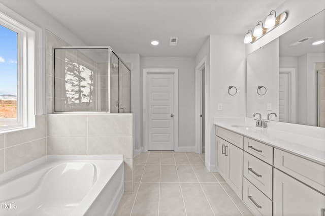 bathroom with tile patterned flooring, a wealth of natural light, vanity, and separate shower and tub