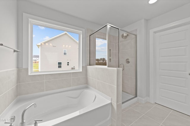 bathroom featuring tile patterned floors and separate shower and tub