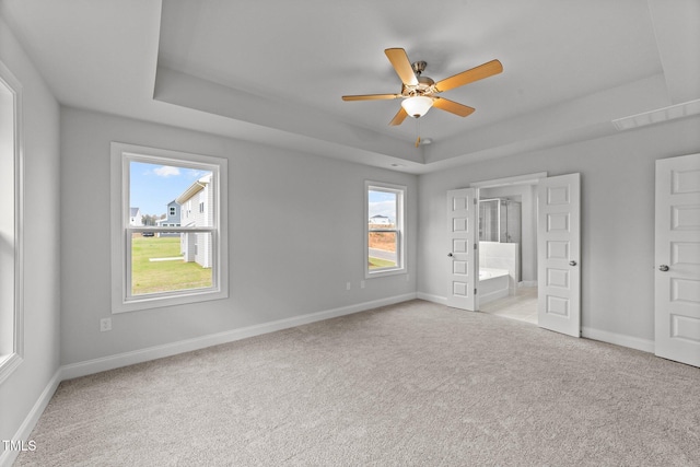 unfurnished bedroom featuring ceiling fan, connected bathroom, and light carpet