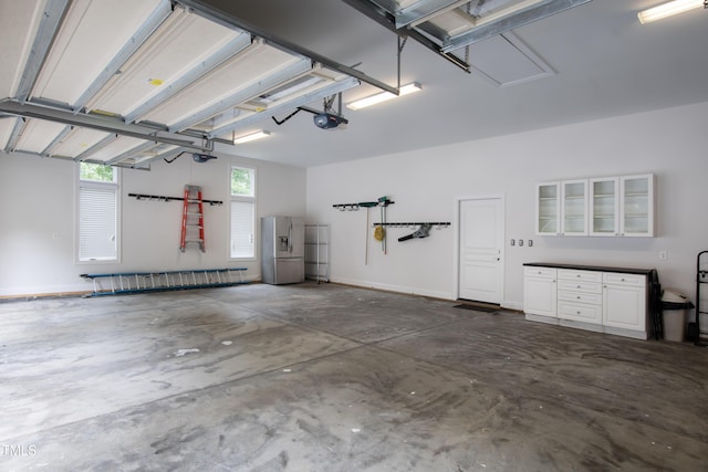 301 Stone Currie Dr, Hillsborough, NC 27278 - garage featuring stainless steel fridge and a garage door opener