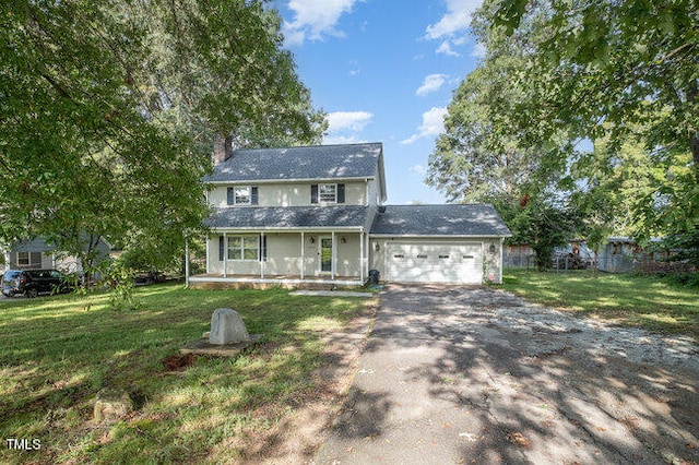 view of front facade featuring a garage, a front lawn, and covered porch