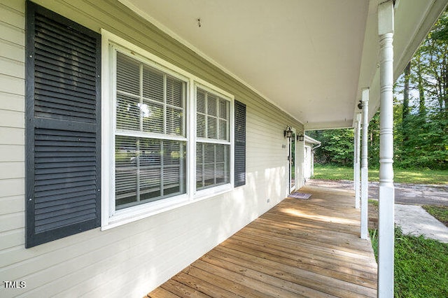 wooden terrace featuring covered porch