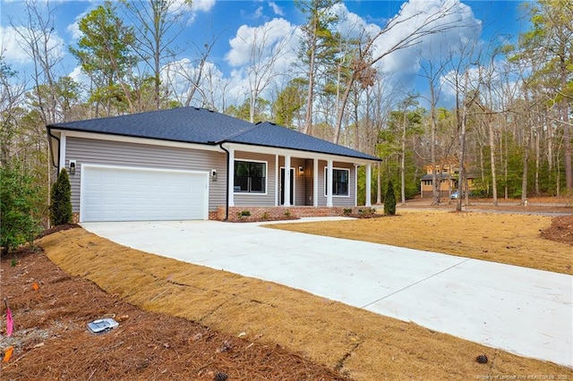 single story home featuring a garage and covered porch