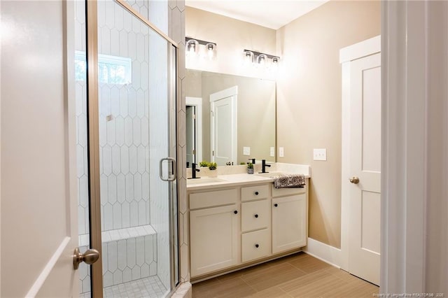 bathroom featuring vanity and a shower with shower door