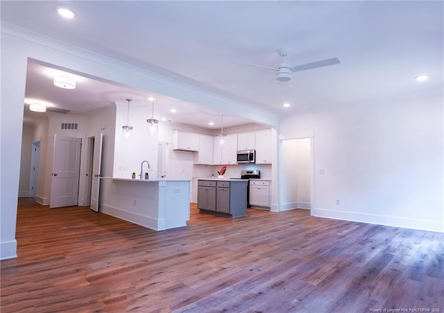 kitchen featuring pendant lighting, sink, light hardwood / wood-style flooring, and white cabinets