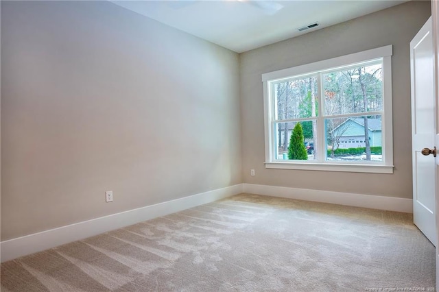 spare room with a healthy amount of sunlight and light colored carpet