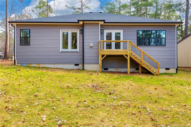 rear view of house featuring a yard and a deck