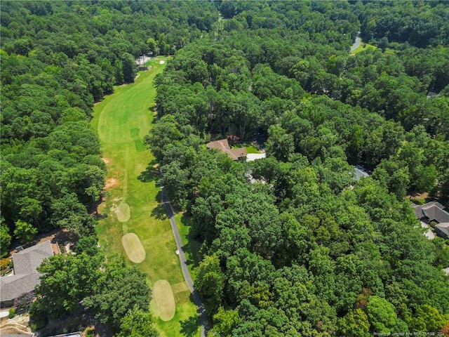 bird's eye view with a wooded view