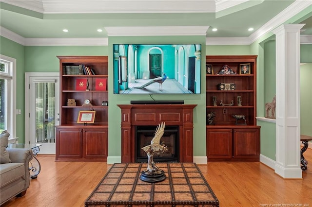 living room featuring recessed lighting, crown molding, a fireplace, and light wood finished floors
