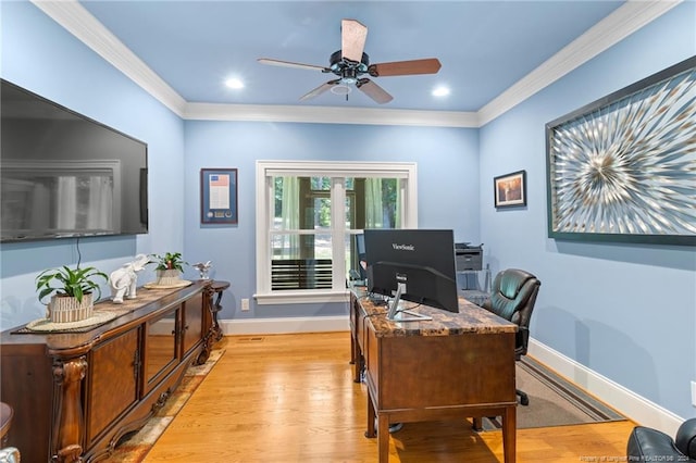 home office featuring a ceiling fan, light wood-style floors, baseboards, and ornamental molding
