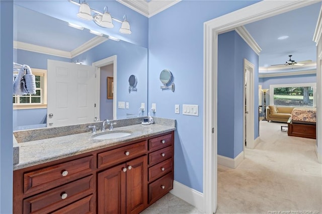 bathroom featuring ensuite bath, crown molding, baseboards, ceiling fan, and vanity