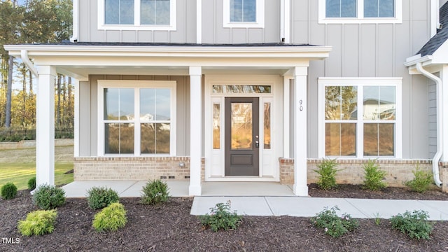 view of exterior entry with a porch